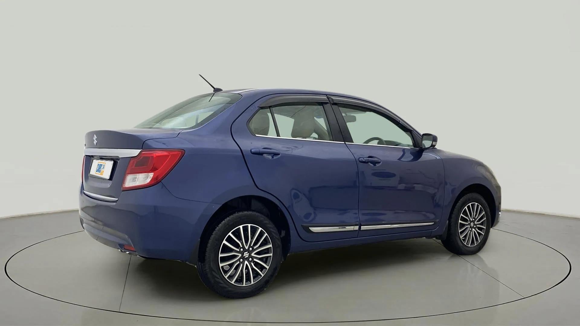 Rear three-quarter of a Alluring Blue Maruti Suzuki Dzire
