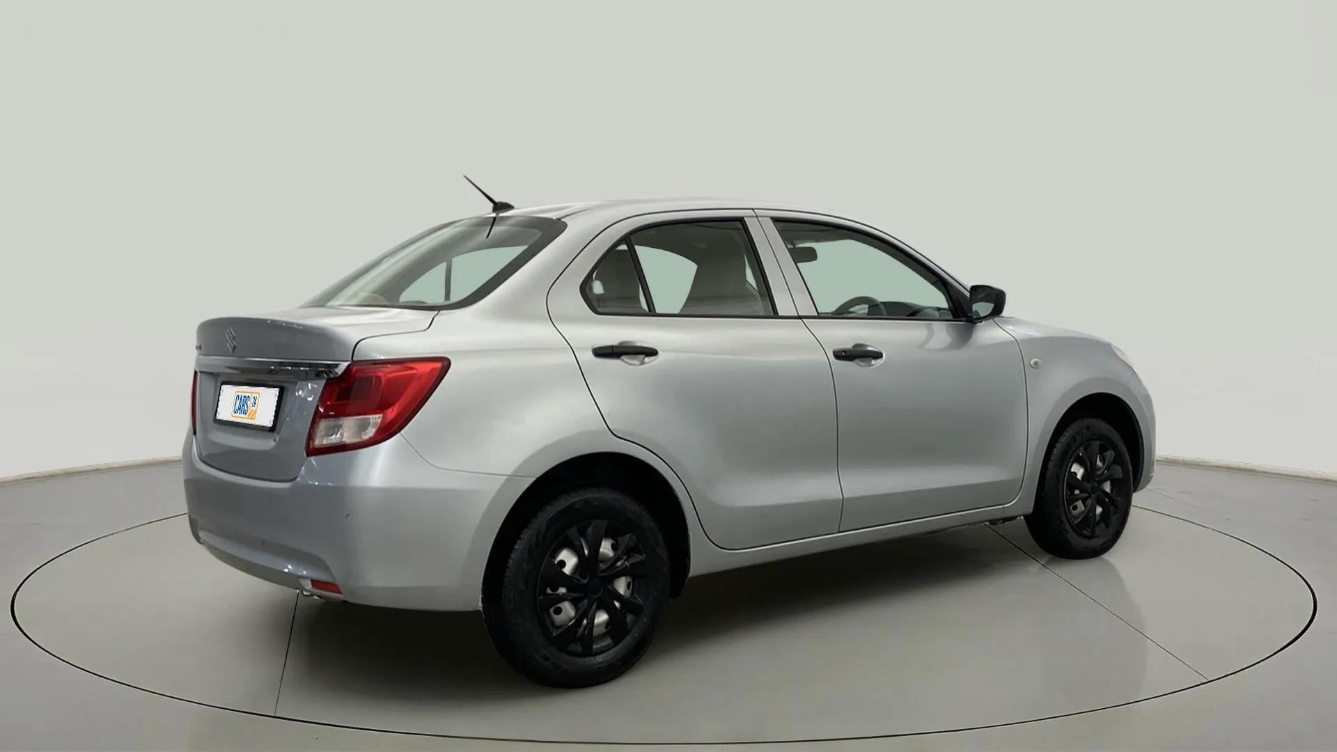 Rear three-quarter of a Splendid Silver Maruti Suzuki Dzire 2018-2023
