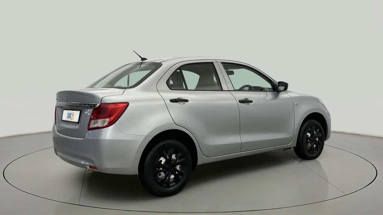 Rear three-quarter of a Splendid Silver Maruti Suzuki Dzire 2018-2023