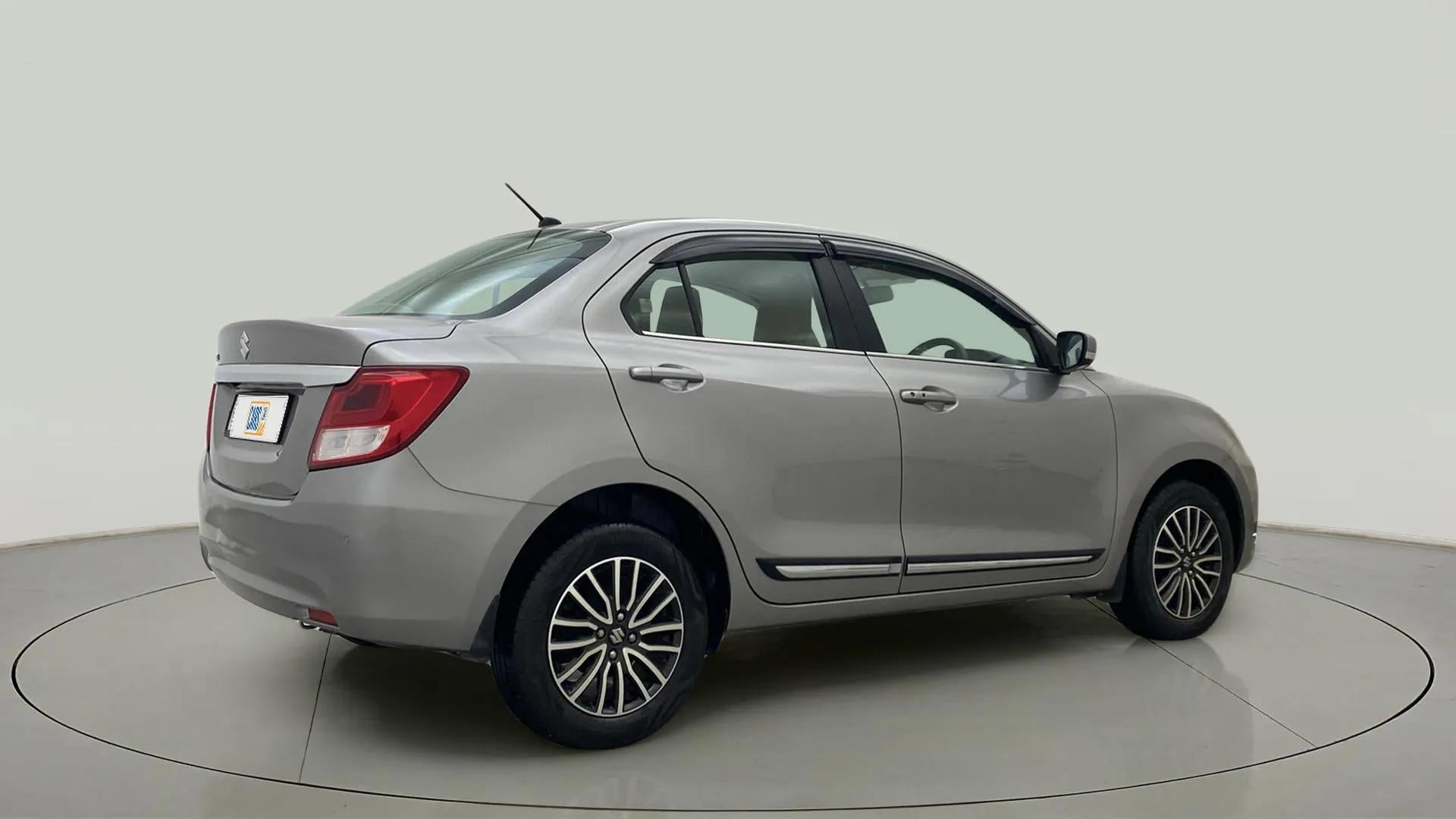 Rear three-quarter view of a splendid silver Maruti Suzuki Dzire 2018-2023