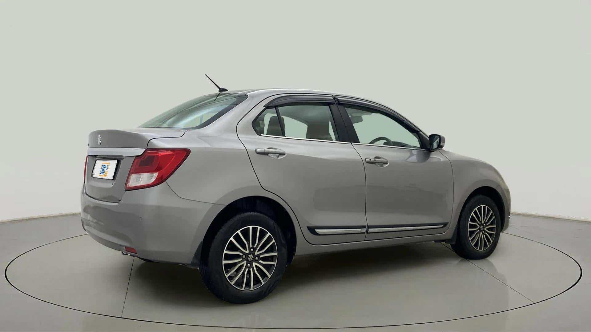 Rear three-quarter view of a splendid silver Maruti Suzuki Dzire 2018-2023