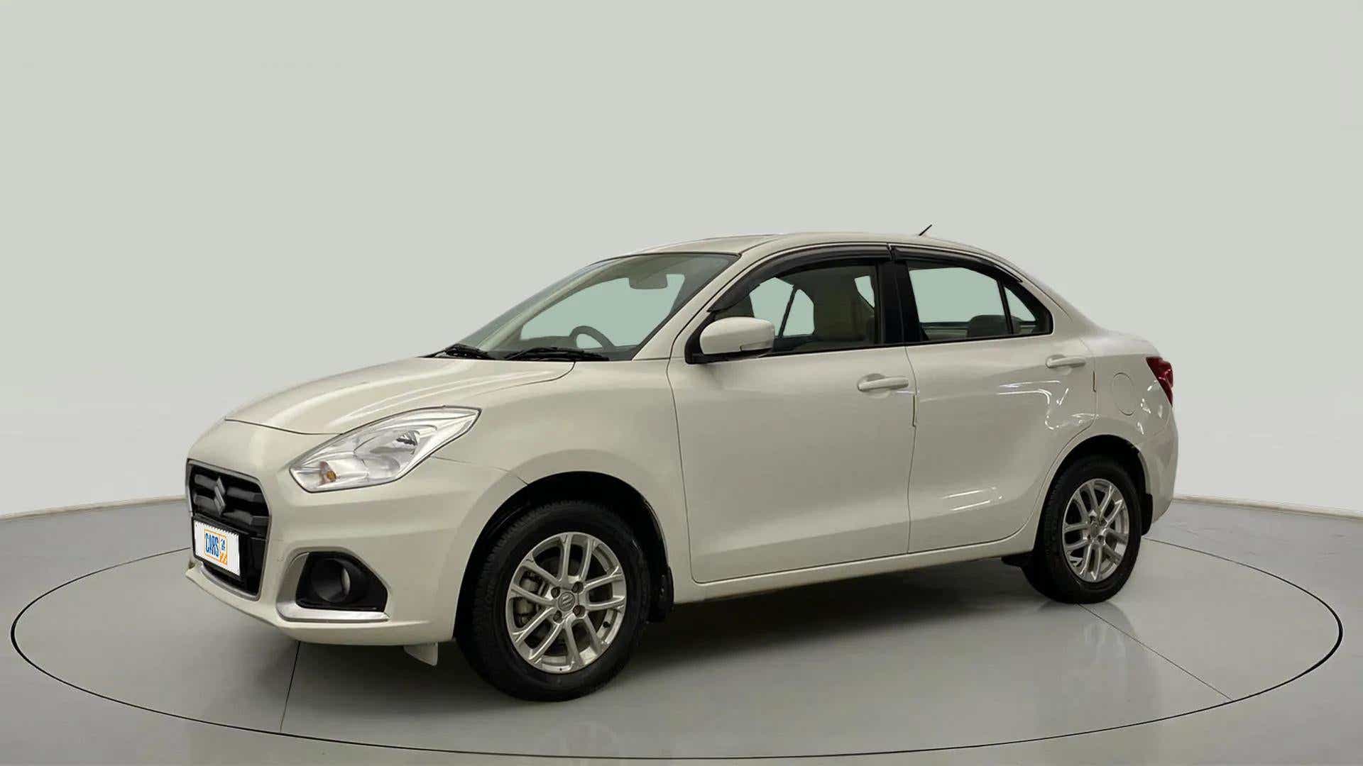 Front three-quarter view of a Pearl Arctic White Maruti Suzuki Dzire