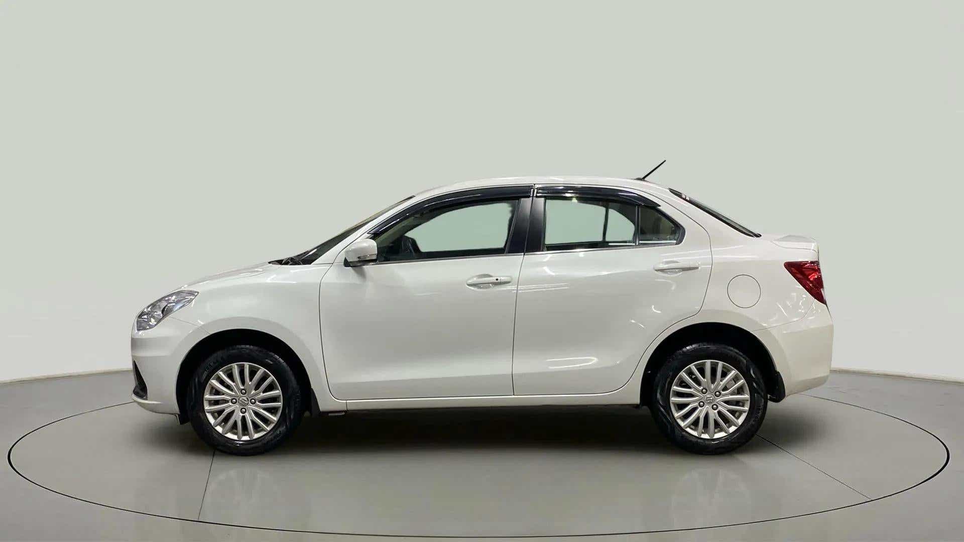 Side view of a Arctic White Maruti Suzuki Dzire 2018-2023