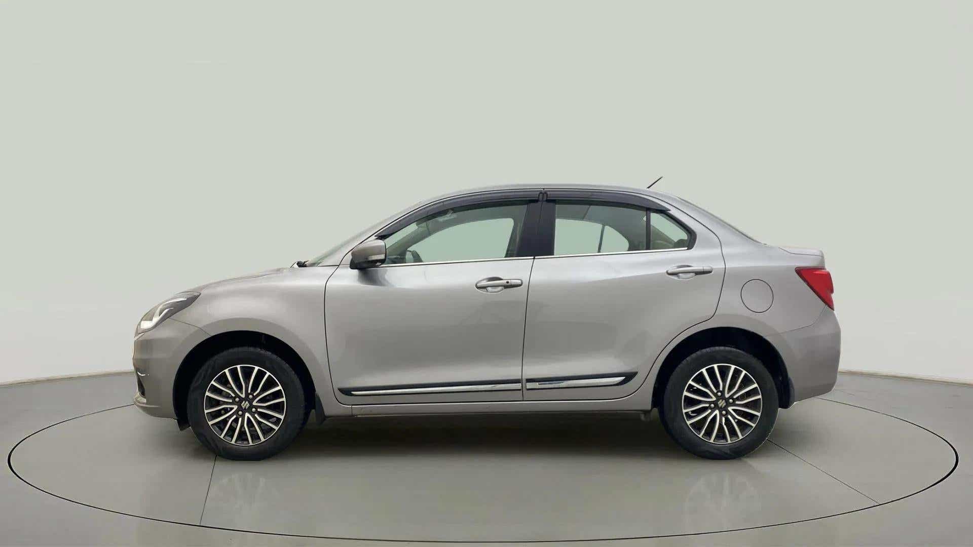 Side view of a splendid silver Maruti Suzuki Dzire 2018-2023