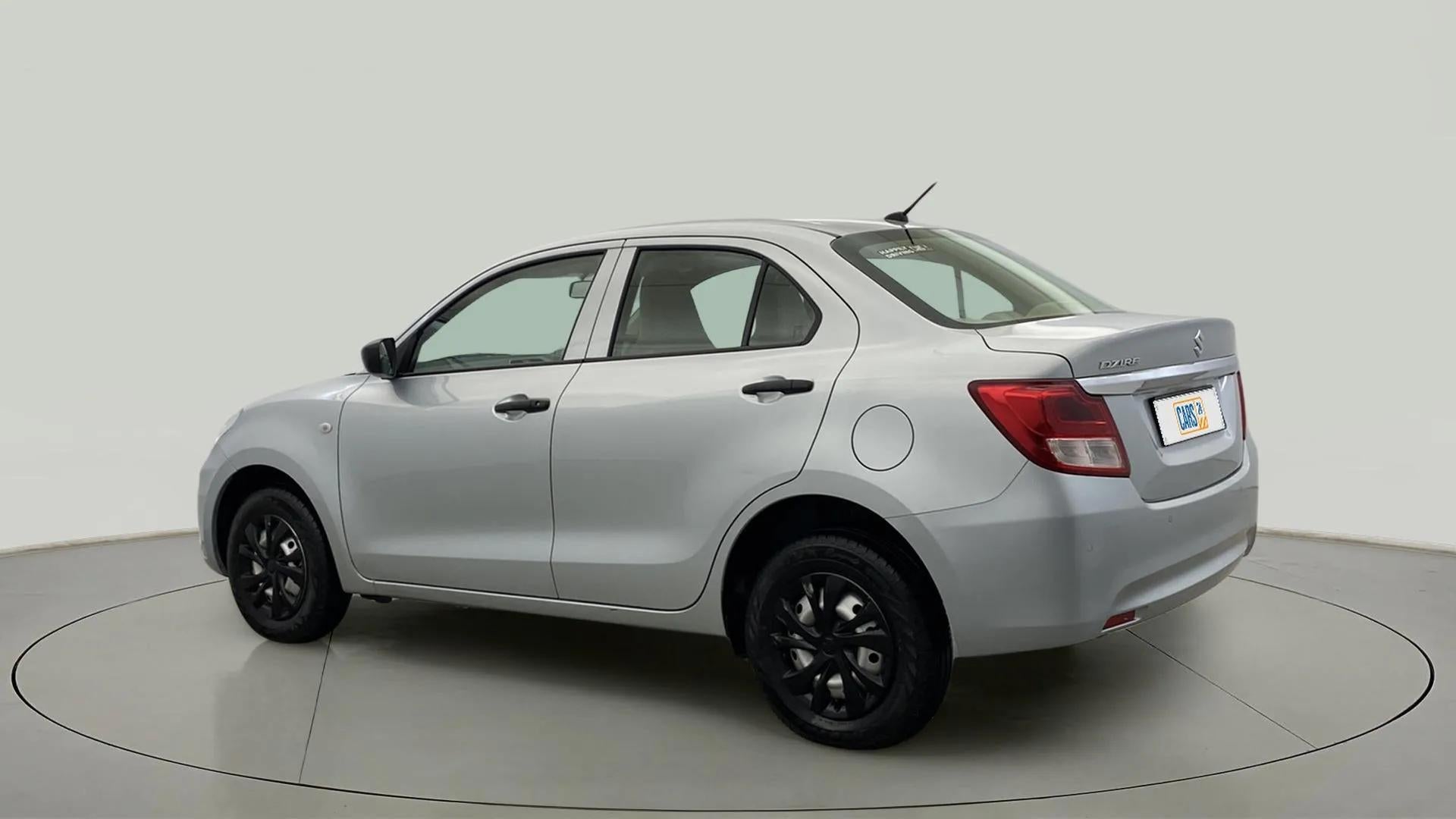 Rear three-quarter view of a splendid silver Maruti Suzuki Dzire 2018-2023