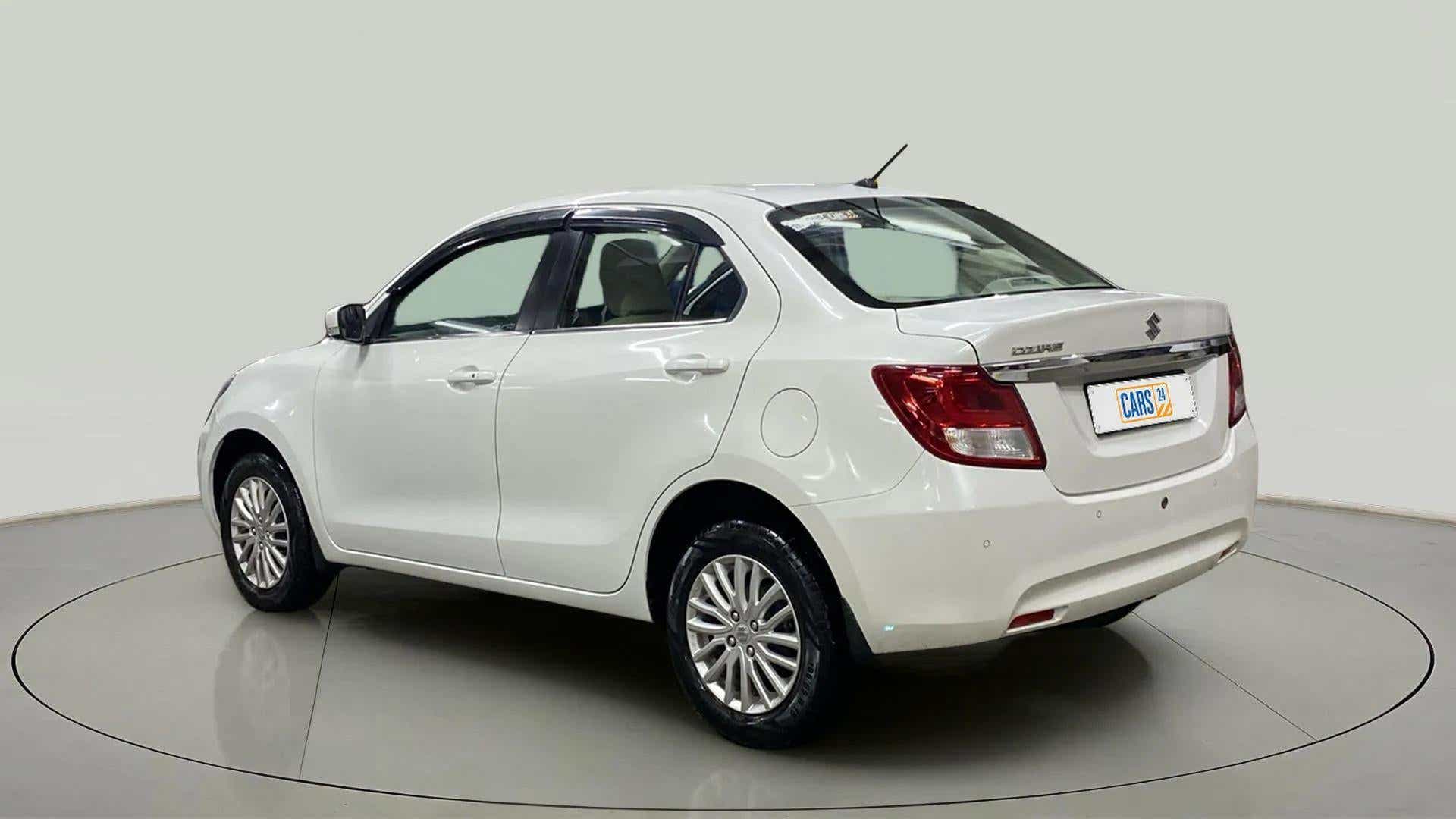 Rear three-quarter of a arctic white Maruti Suzuki Dzire 2018-2023