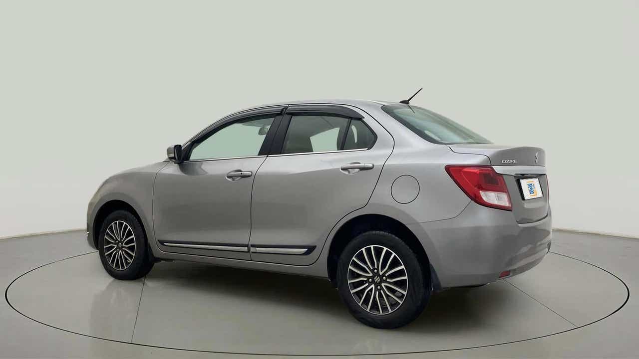 Rear three-quarter of a Splendid Silver Maruti Suzuki Dzire 2018-2023