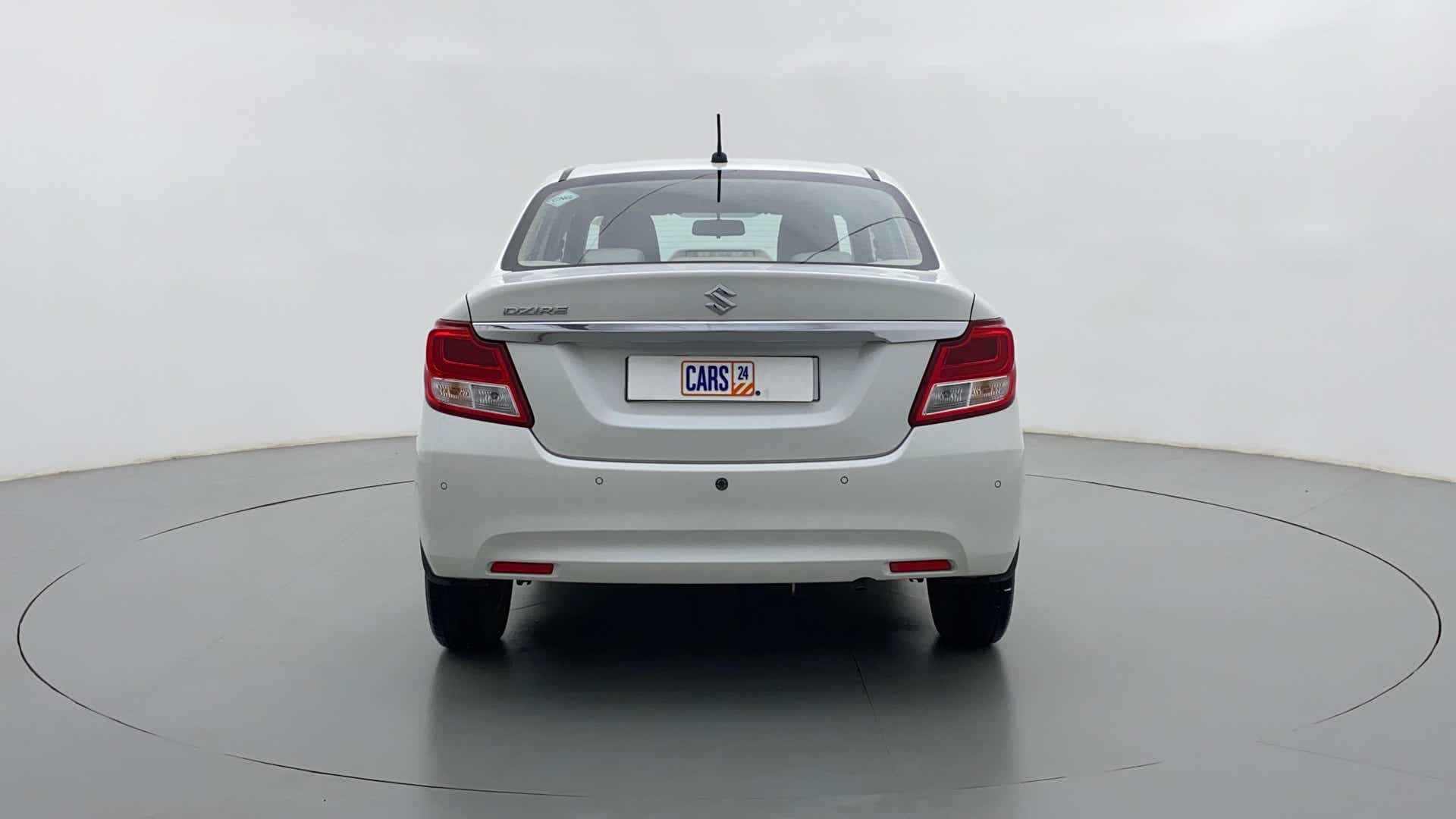 Rear view of a arctic white Maruti Suzuki Dzire 2018-2023