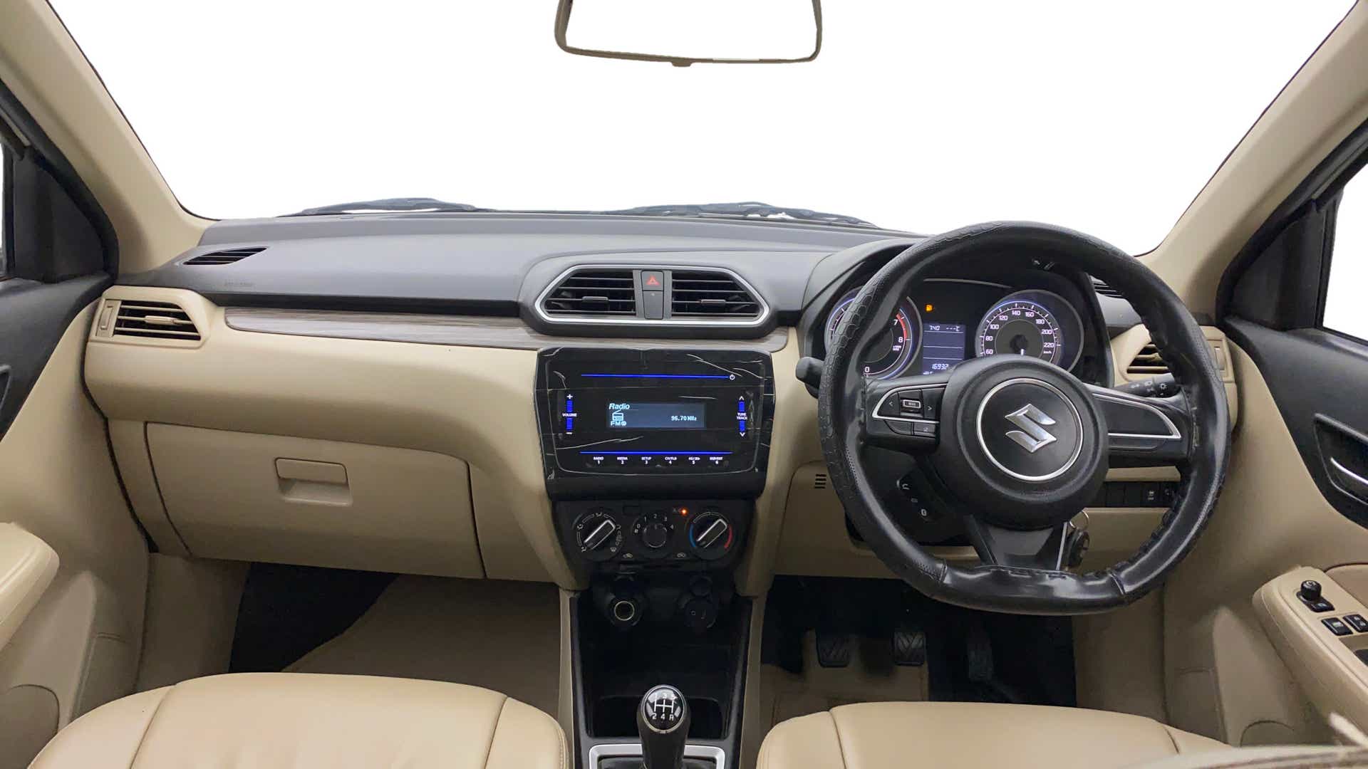 Interior dashboard view of a Maruti Suzuki Dzire