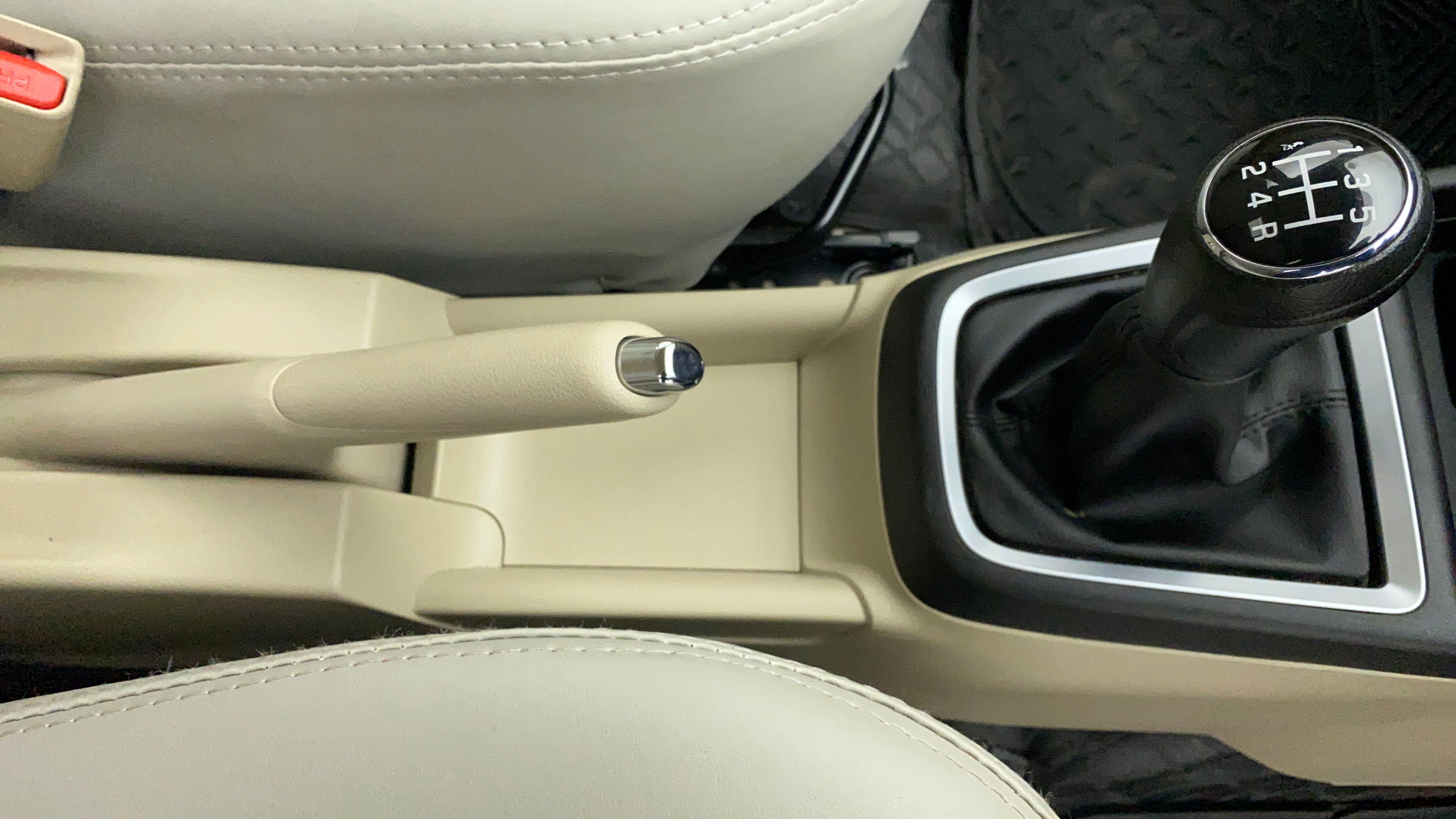 Center console with handbrake and gear lever of a Maruti Suzuki Dzire 2018-2023