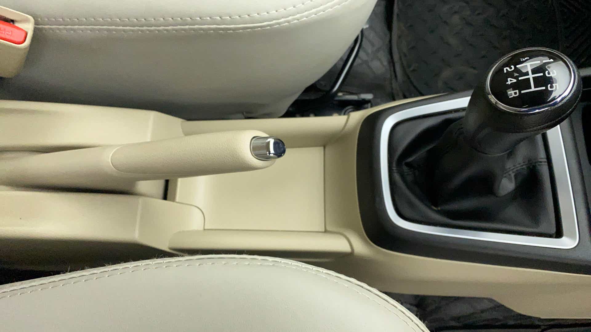 Center console with handbrake and gear lever of a Maruti Suzuki Dzire 2018-2023