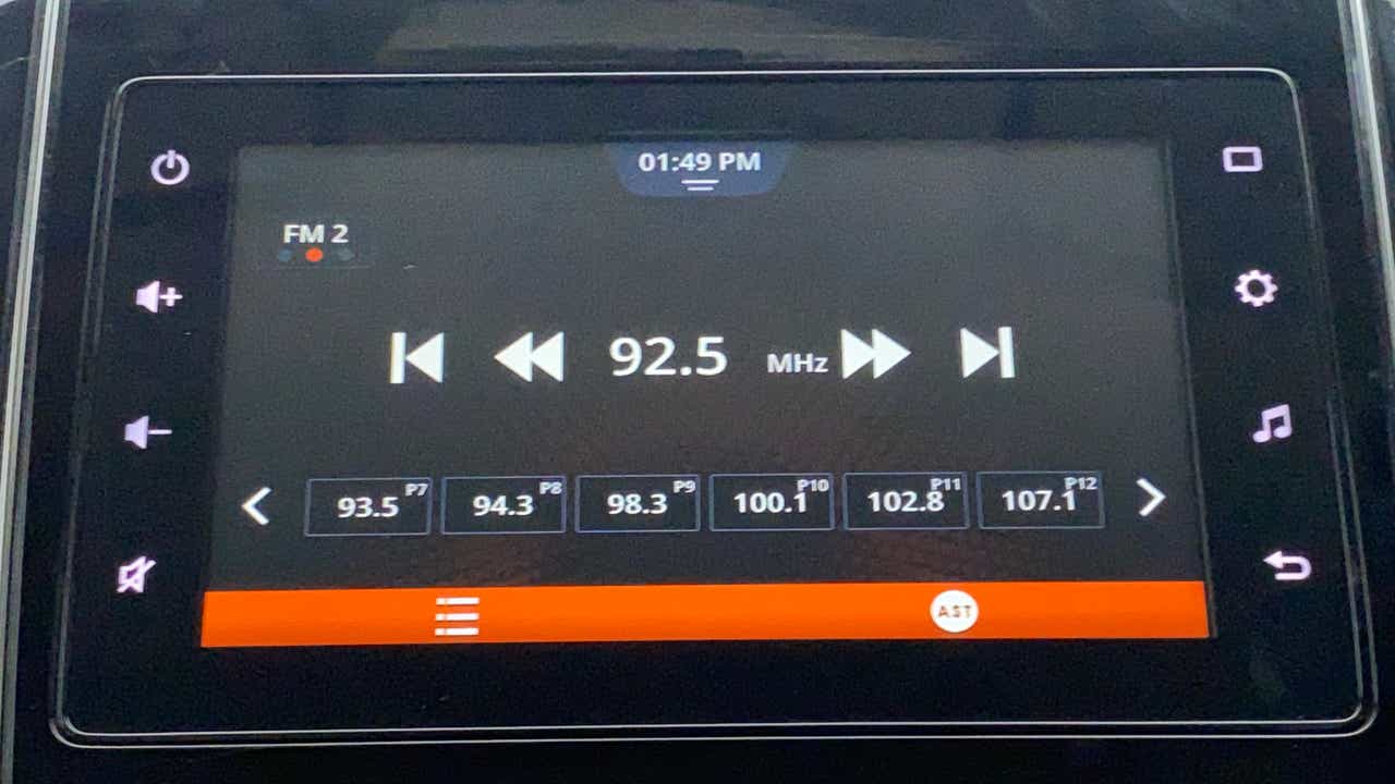 Car stereo display showing radio tuning screen of a Maruti Suzuki Dzire 2018-2023