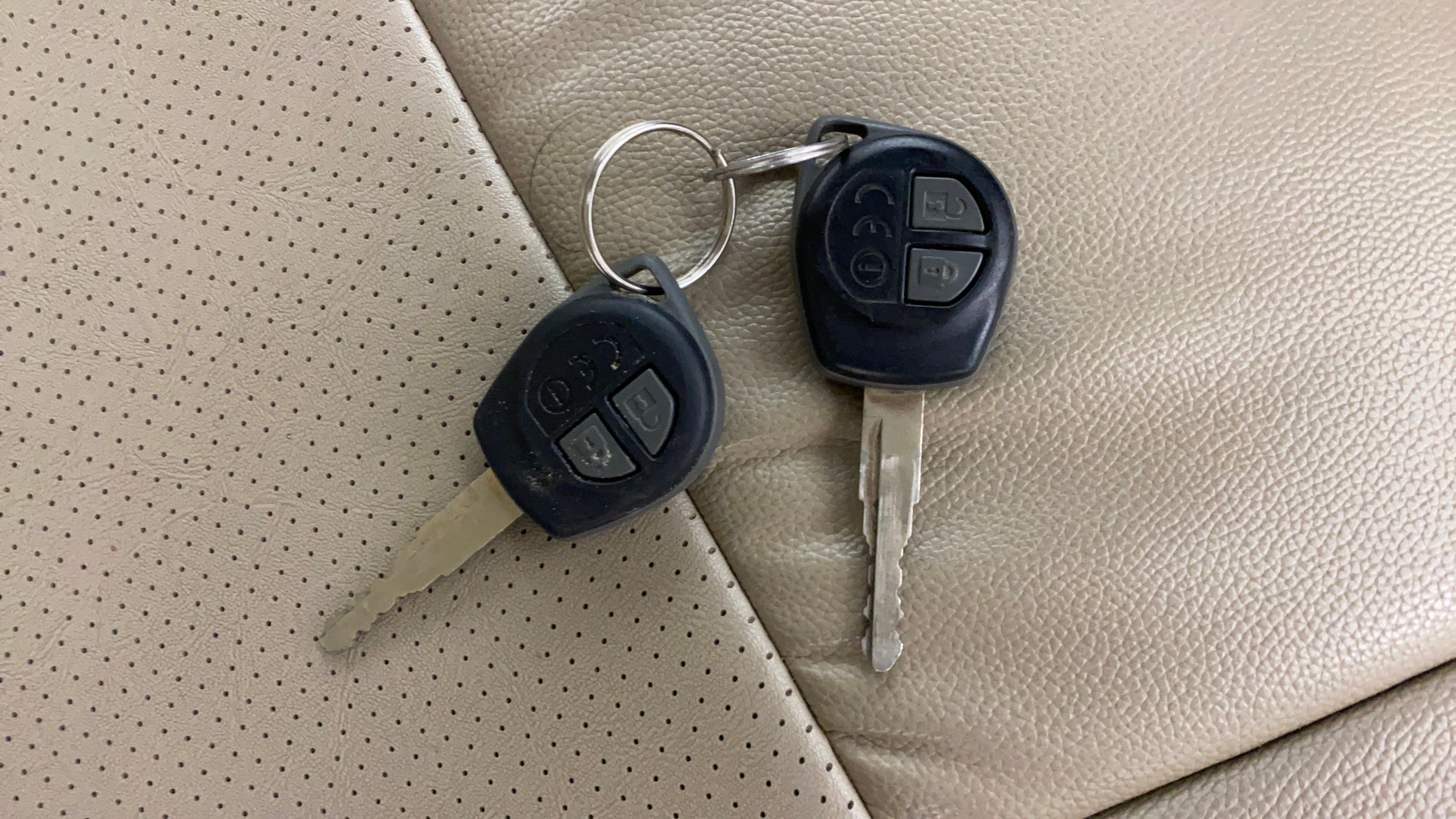 Car keys on the seat of a Maruti Suzuki Dzire
