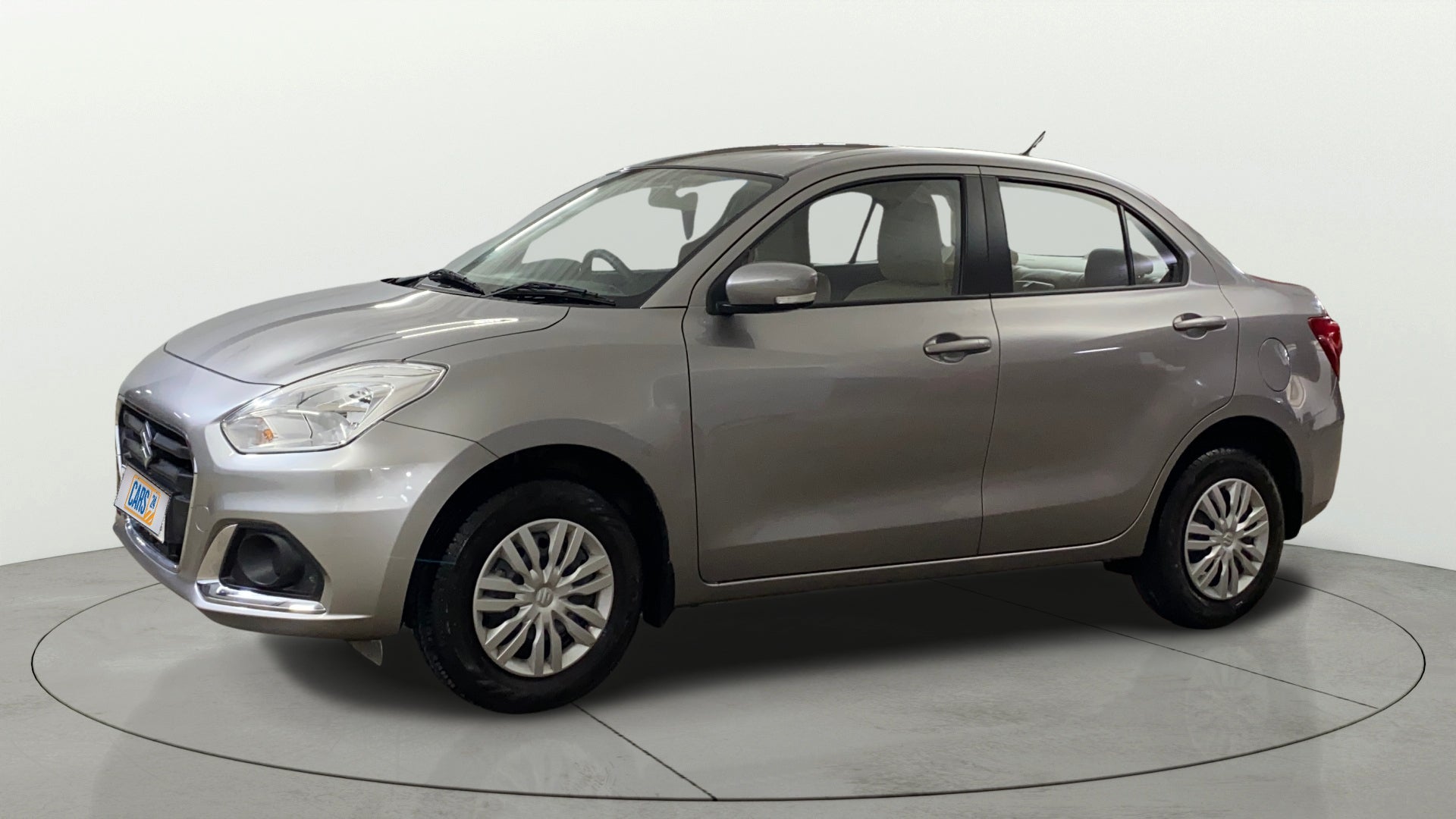 Side view of a Splendid Silver Maruti Suzuki Dzire 2018-2023