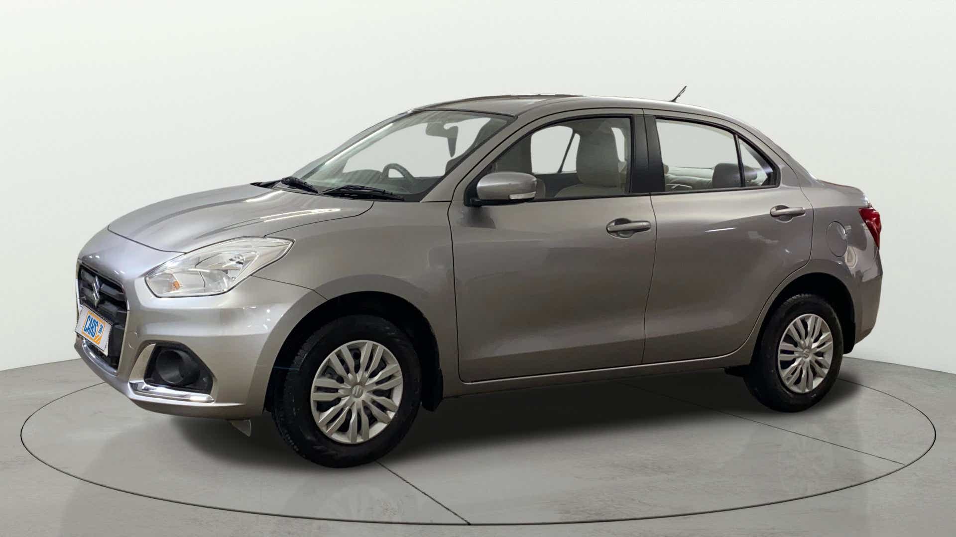 Side view of a Splendid Silver Maruti Suzuki Dzire 2018-2023