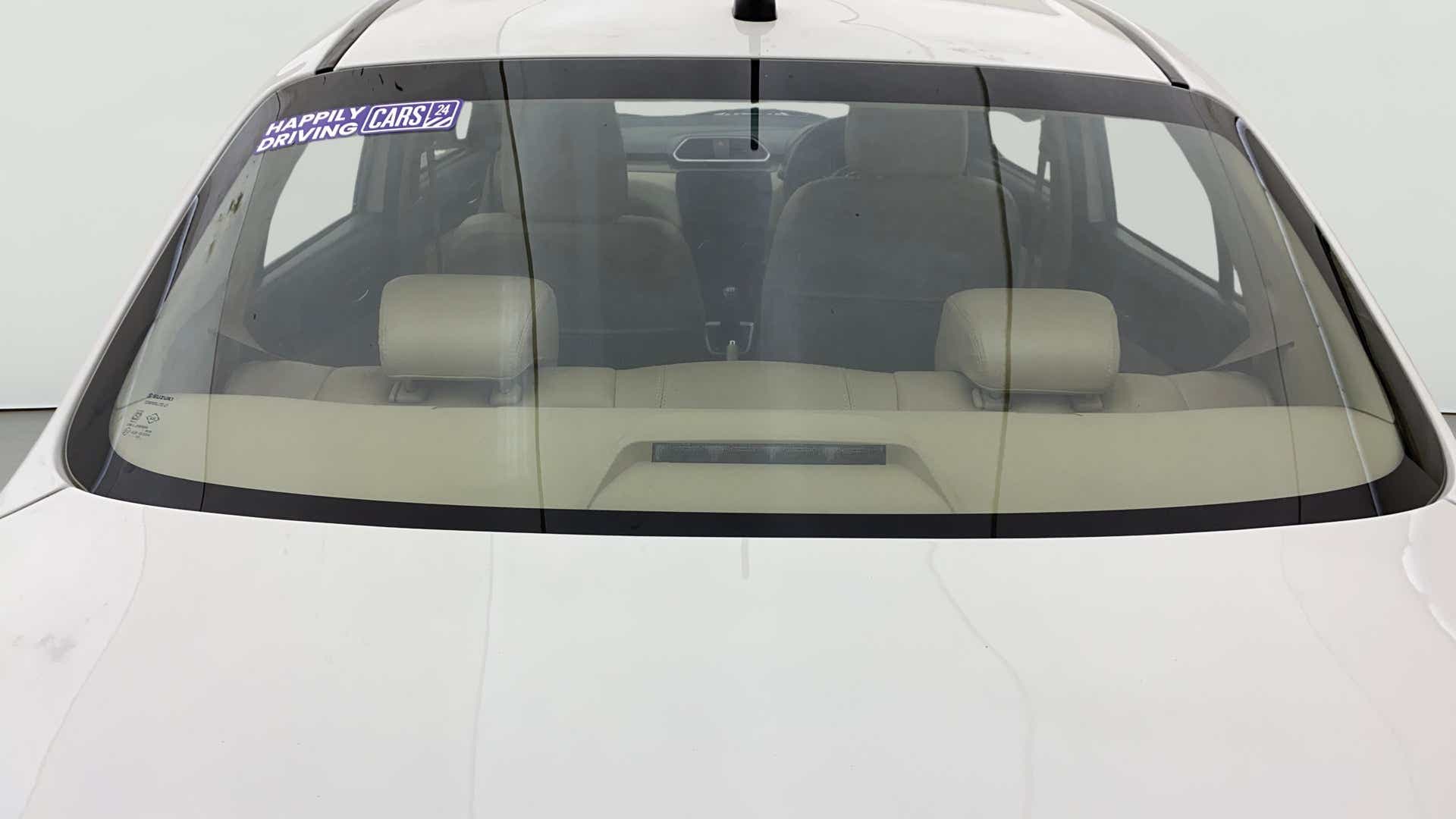 Rear windshield view of a Maruti Suzuki Dzire