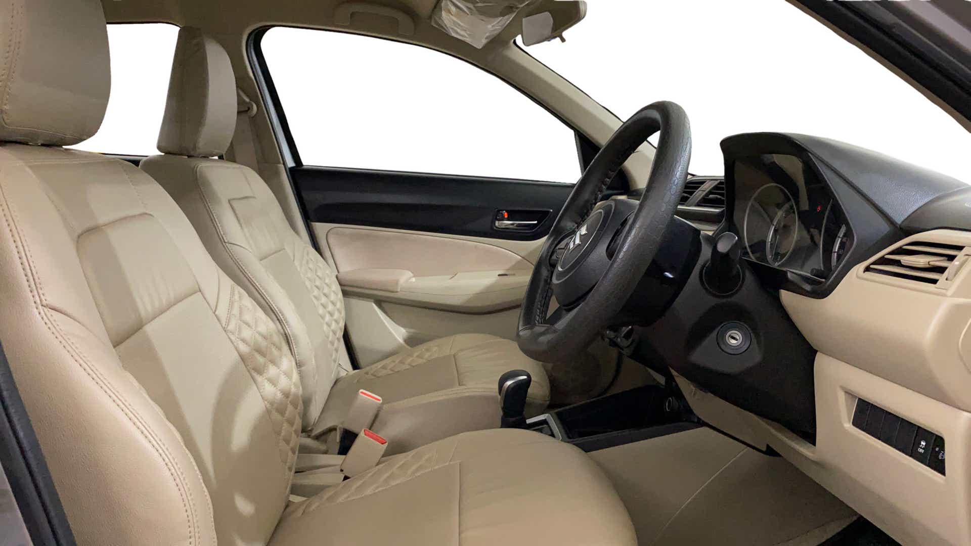 Interior front seats and dashboard of a Maruti Suzuki Dzire 2018-2023