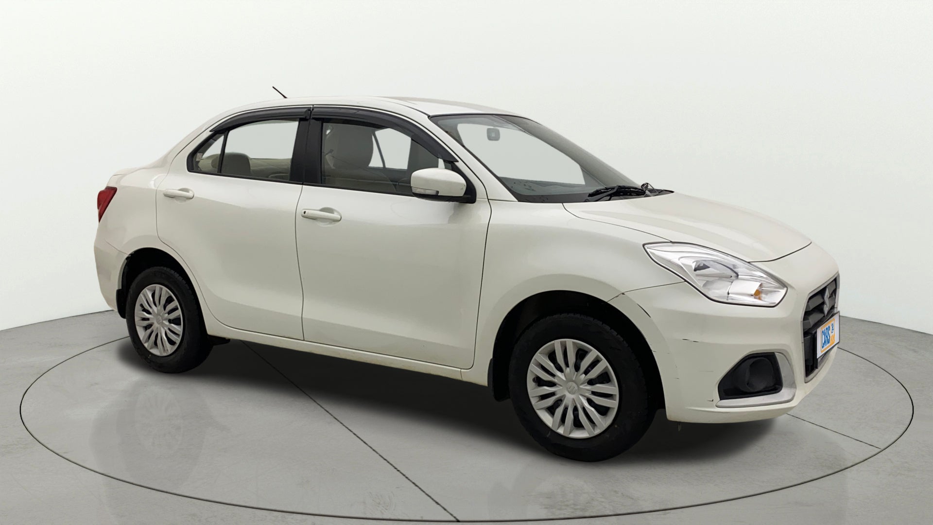 Front three-quarter view of a Pearl Arctic White Maruti Suzuki Dzire