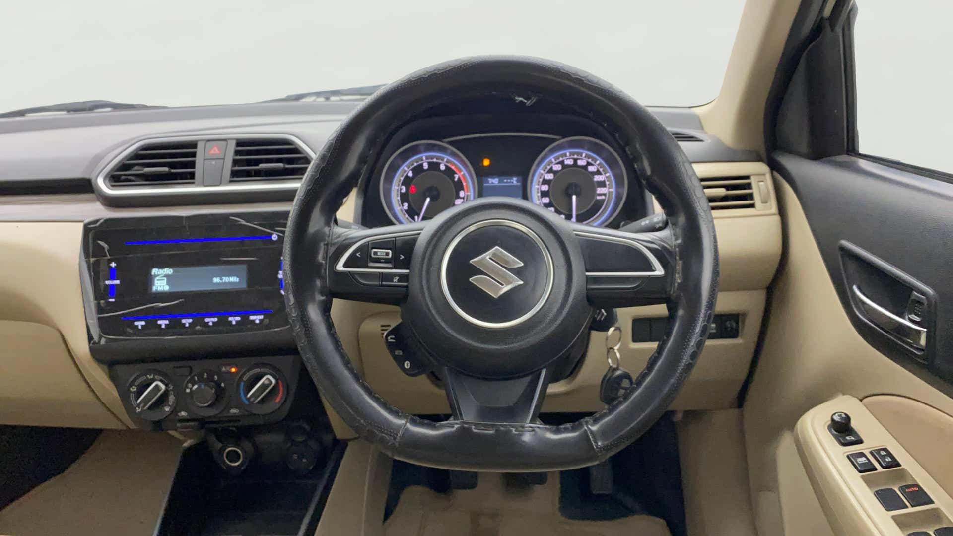 Interior dashboard view of a Maruti Suzuki Dzire