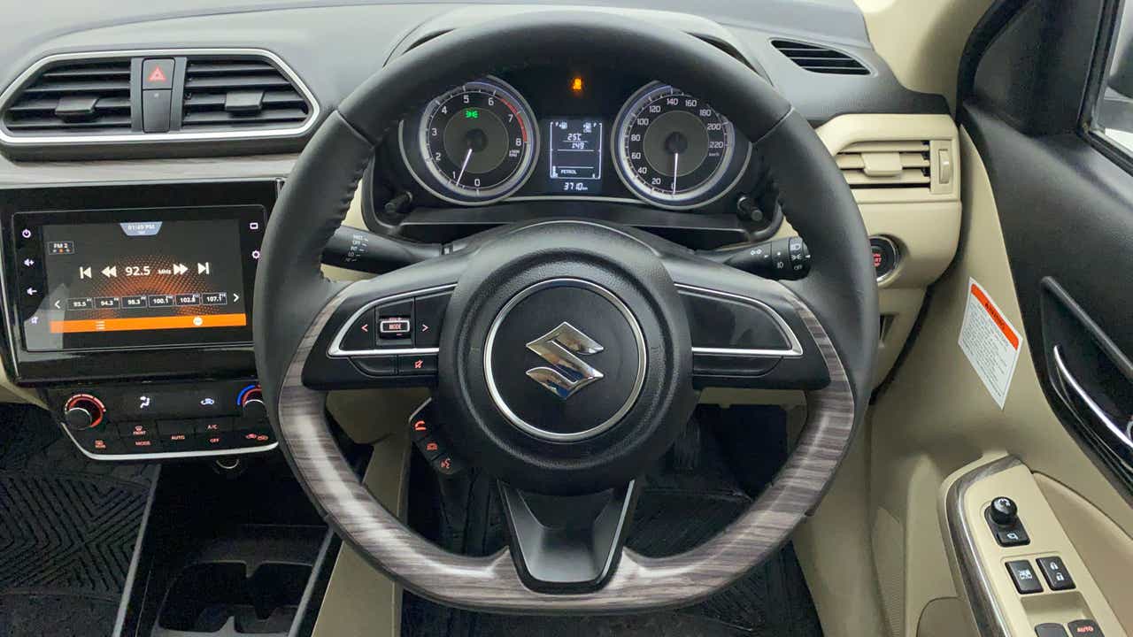 Interior dashboard and steering wheel of a Maruti Suzuki Dzire 2018-2023