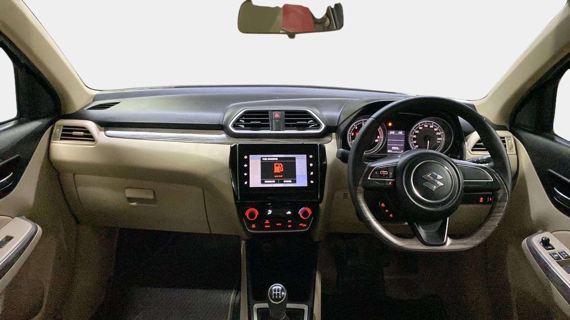 Interior dashboard view of a Maruti Suzuki Dzire 2018-2023