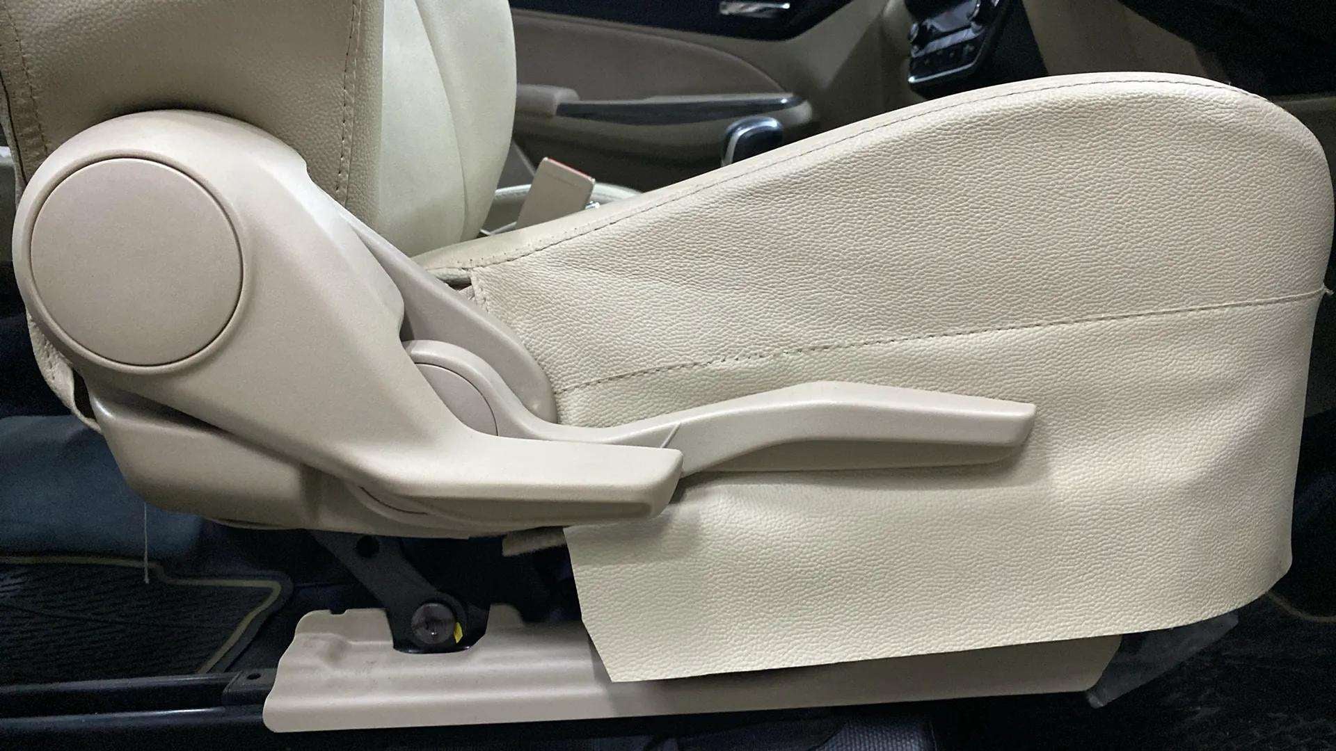 Close-up of a front seat adjustment lever in a Maruti Suzuki Dzire 2018-2023