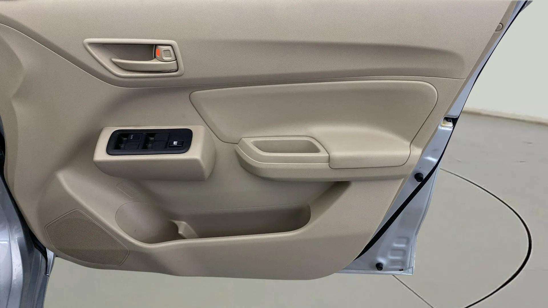 Interior driver-side door panel of a Maruti Suzuki Dzire 2018-2023