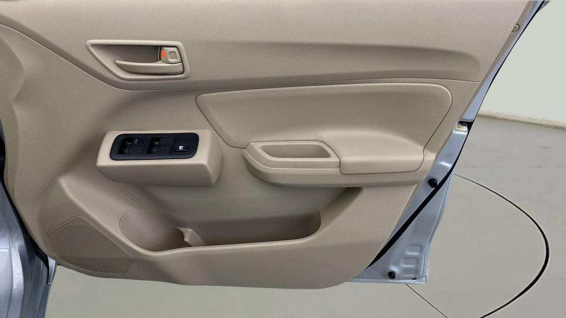 Interior driver-side door panel of a Maruti Suzuki Dzire 2018-2023