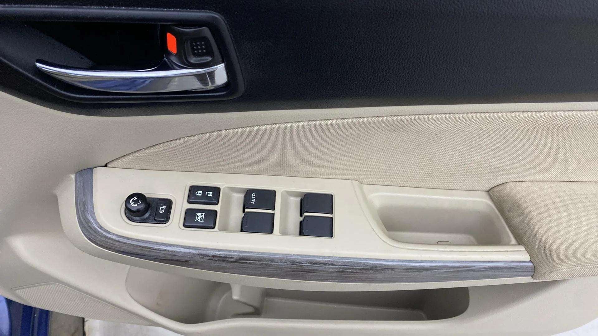 Driver side door controls of a Maruti Suzuki Dzire