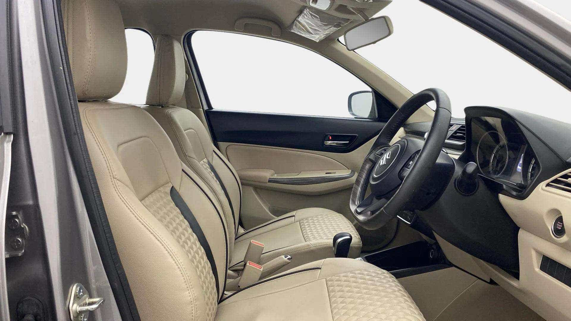 Interior front seats and dashboard of a Maruti Suzuki Dzire 2018-2023