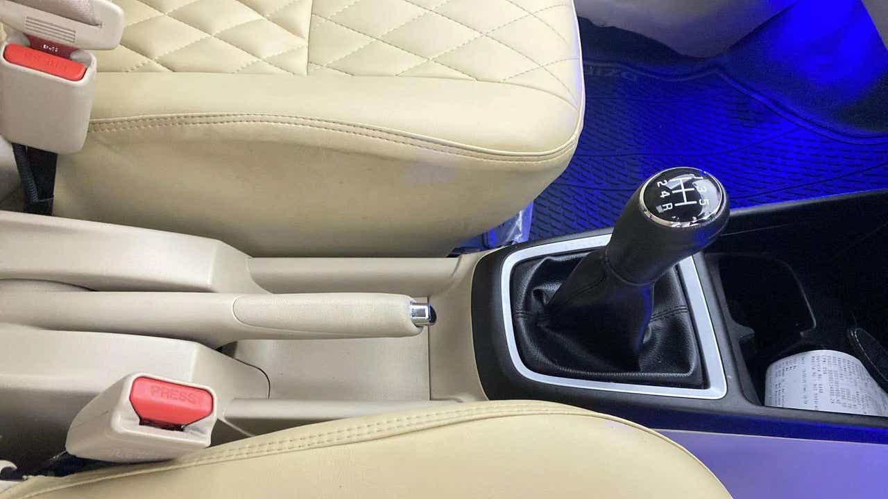 Gear stick and handbrake area of a Maruti Suzuki Dzire