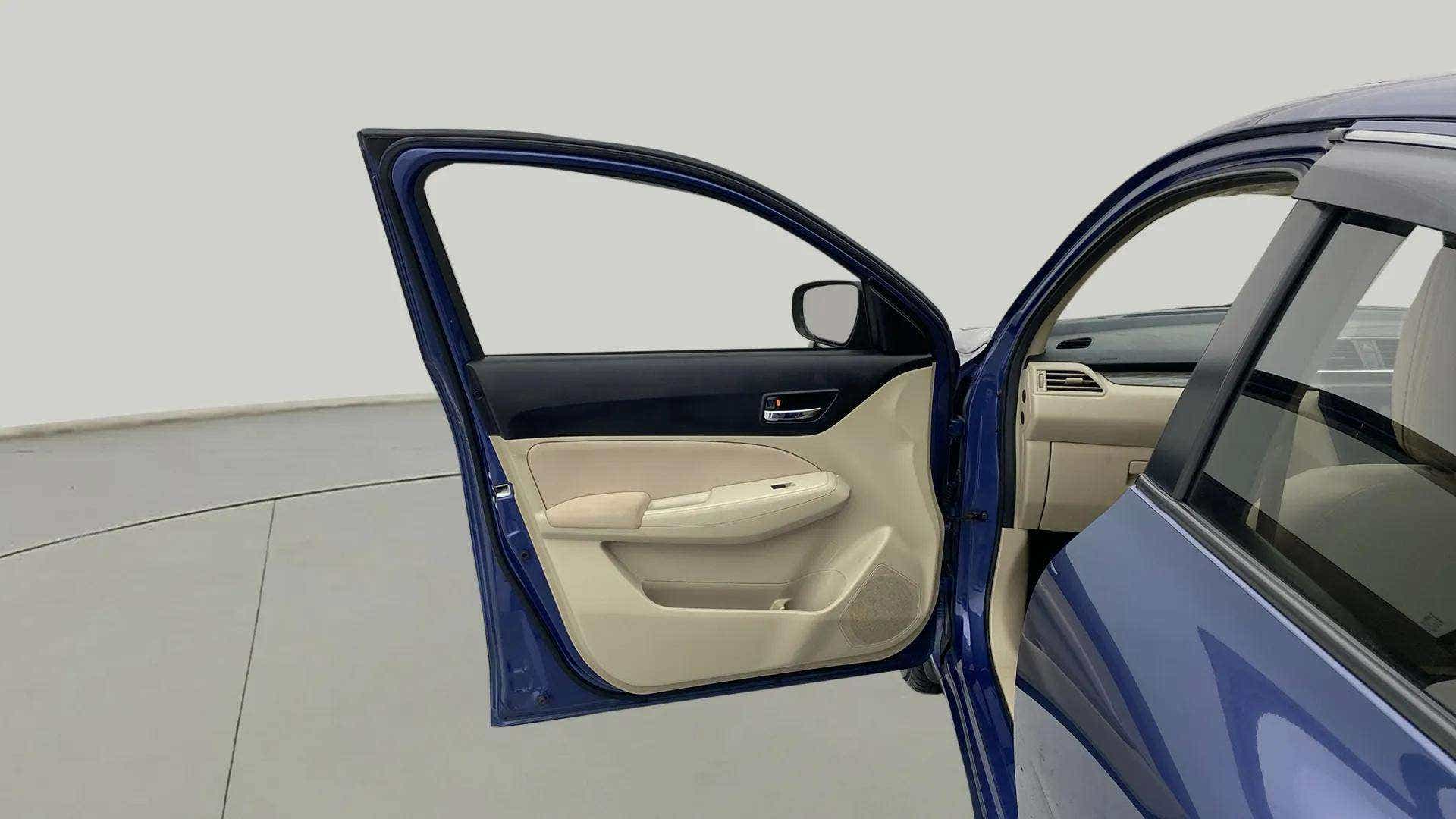 Front driver-side door interior of a Maruti Suzuki Dzire 2018-2023