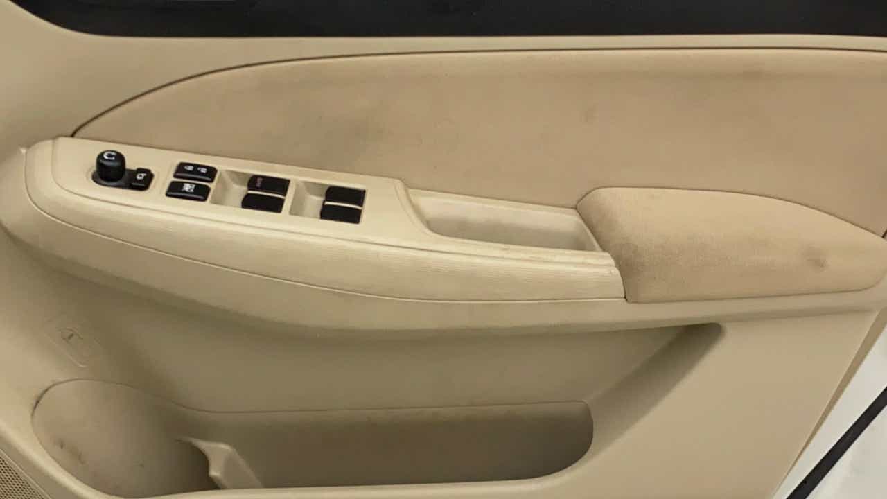 Driver side interior door panel of a Maruti Suzuki Dzire