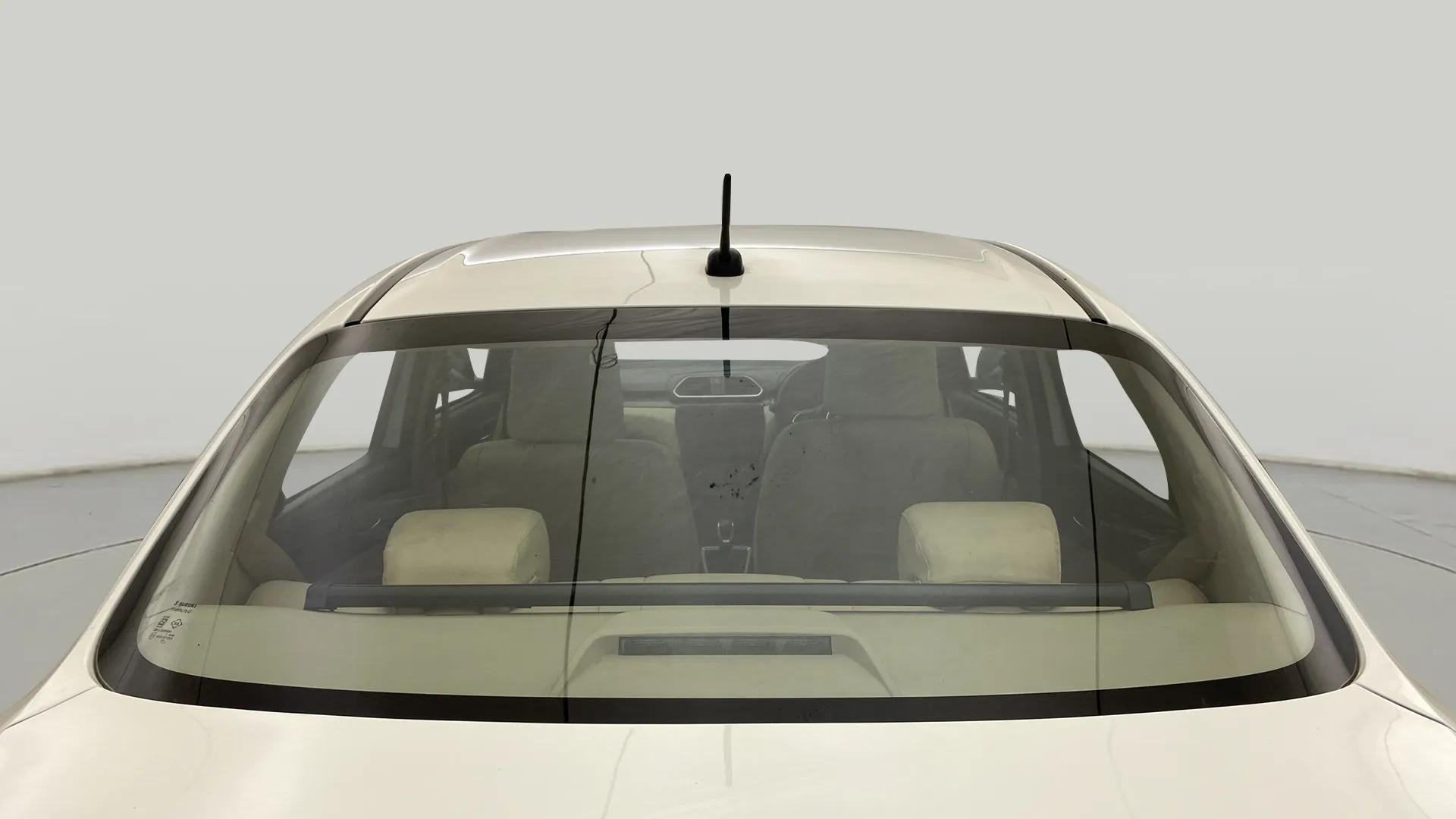 Rear windshield view of a Maruti Suzuki Dzire