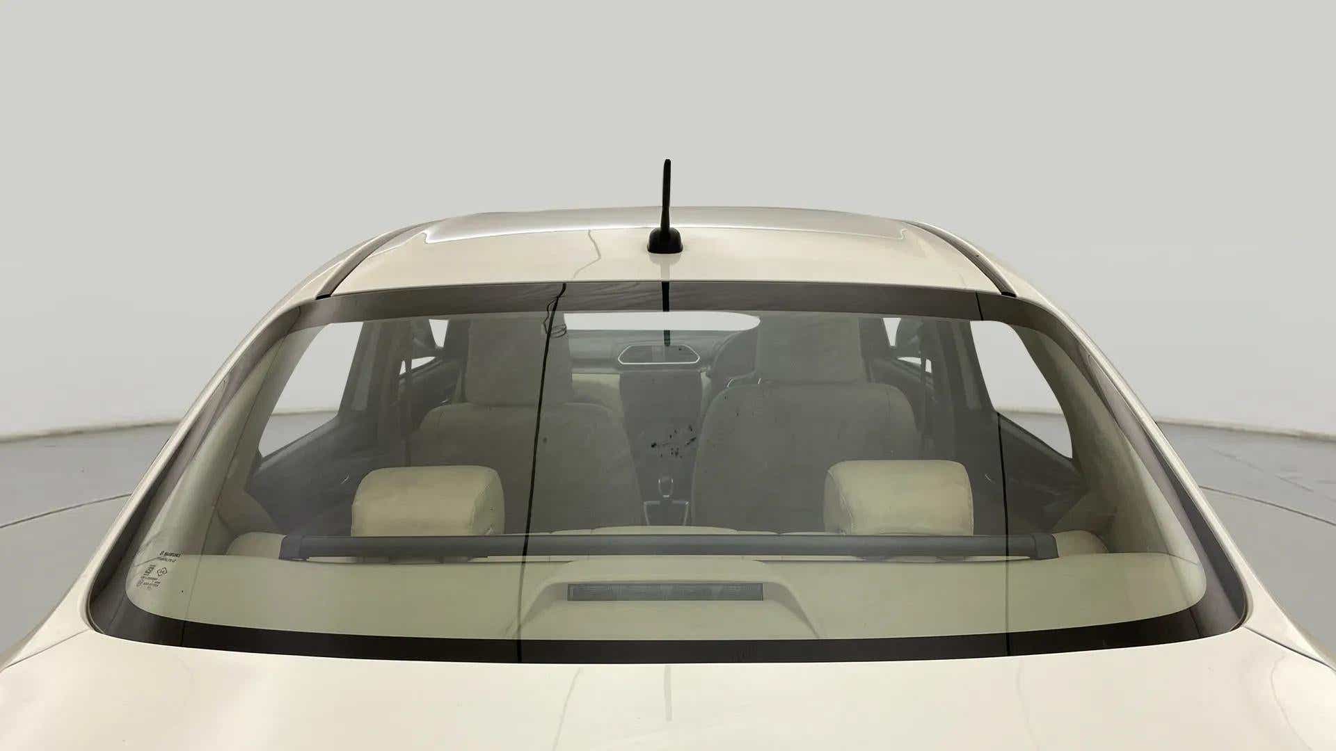 Rear windshield view of a Maruti Suzuki Dzire