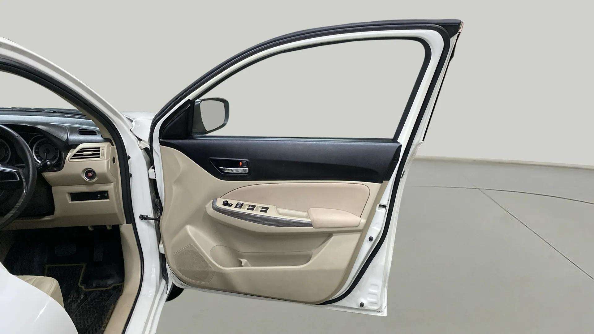 Interior driver-side door panel of a Maruti Suzuki Dzire 2018-2023