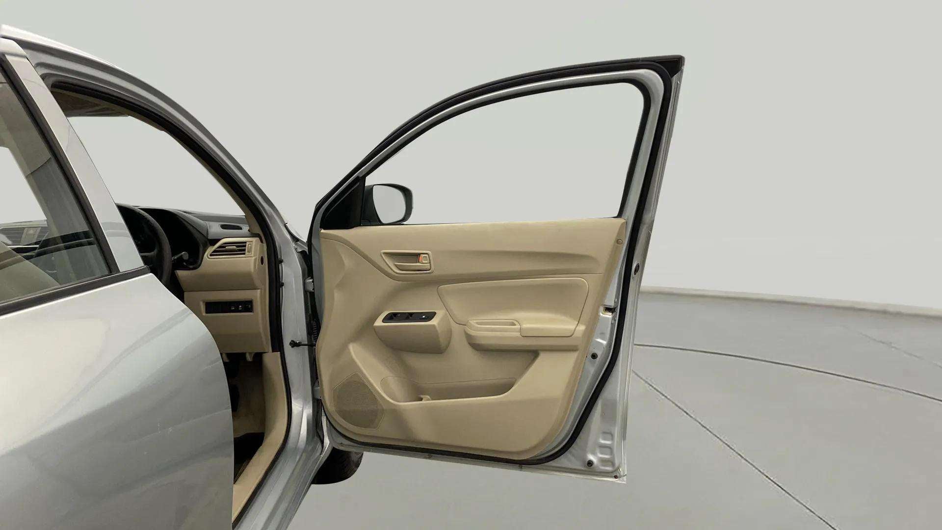 Driver side open door view of a Maruti Suzuki Dzire 2018-2023