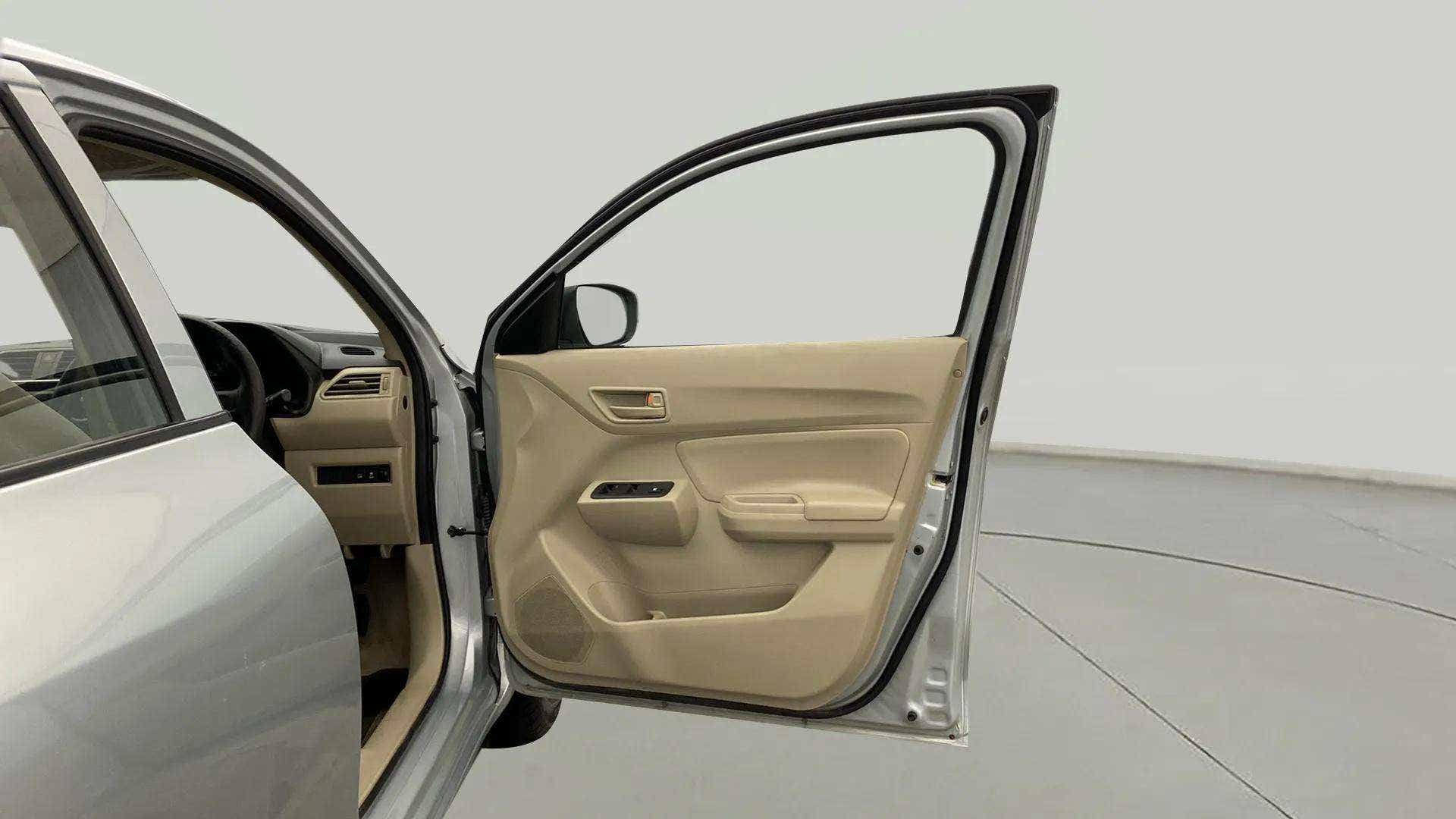 Driver side open door view of a Maruti Suzuki Dzire 2018-2023