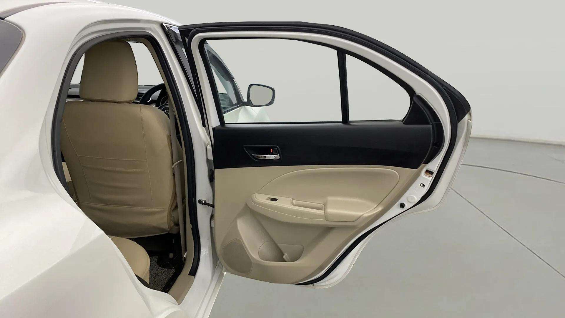 Rear left door open view of a Maruti Suzuki Dzire