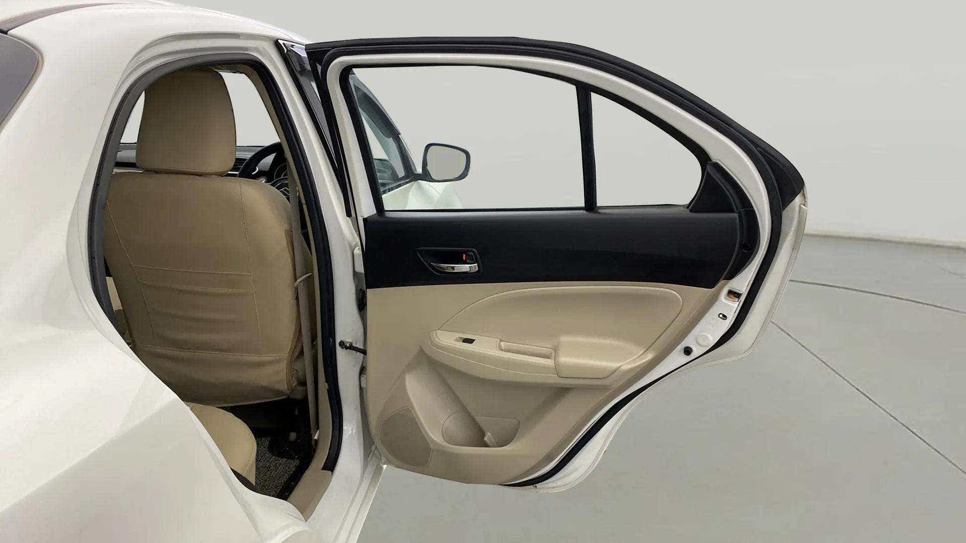 Rear left door open view of a Maruti Suzuki Dzire