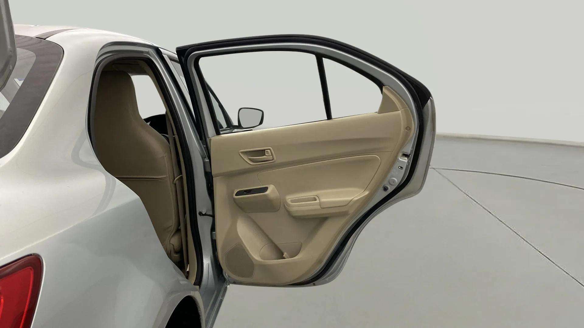 Rear door interior of a arctic white Maruti Suzuki Dzire 2018-2023
