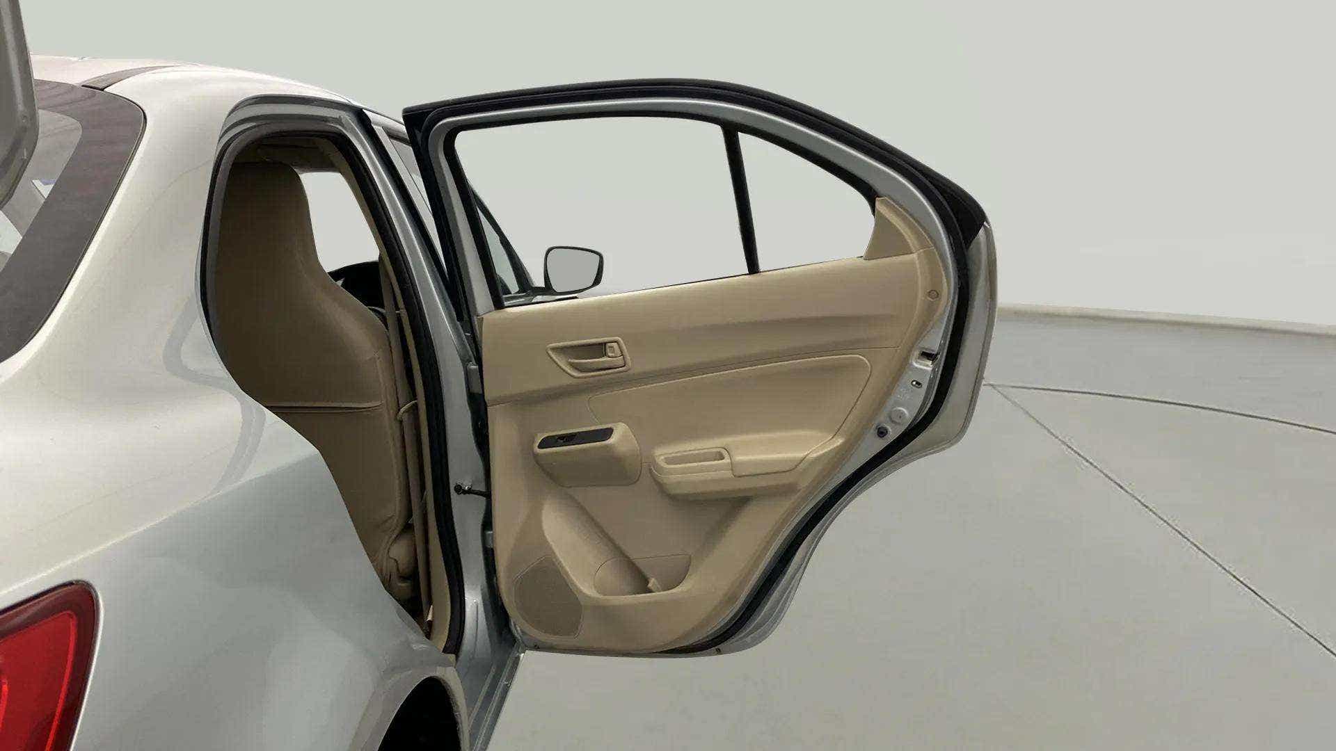 Rear door interior of a arctic white Maruti Suzuki Dzire 2018-2023