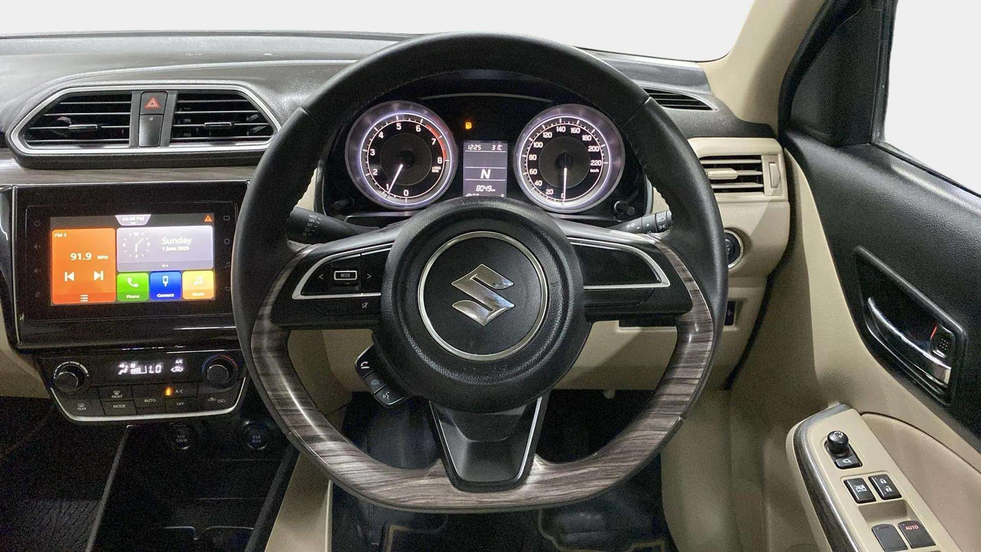 Dashboard and steering wheel view of a Maruti Suzuki Dzire 2018-2023