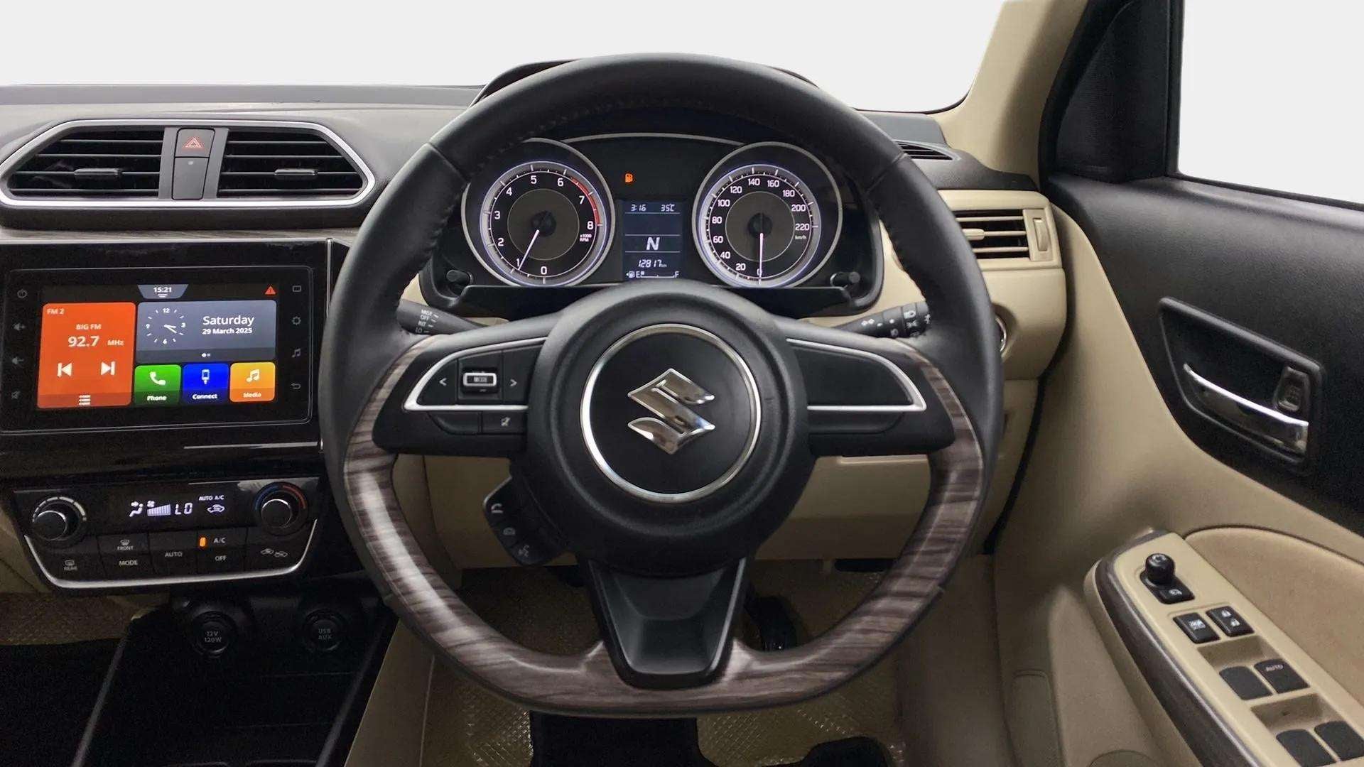 Dashboard and steering wheel of a Maruti Suzuki Dzire