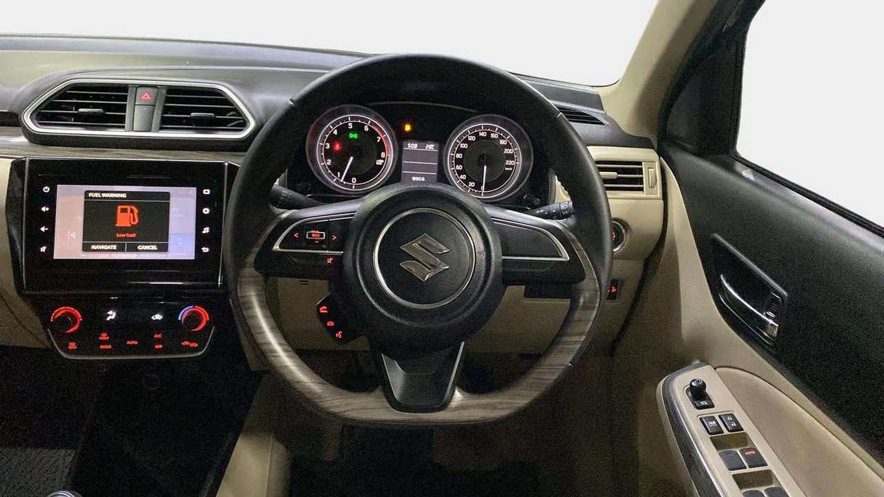 Dashboard and steering wheel view of a Maruti Suzuki Dzire 2018-2023