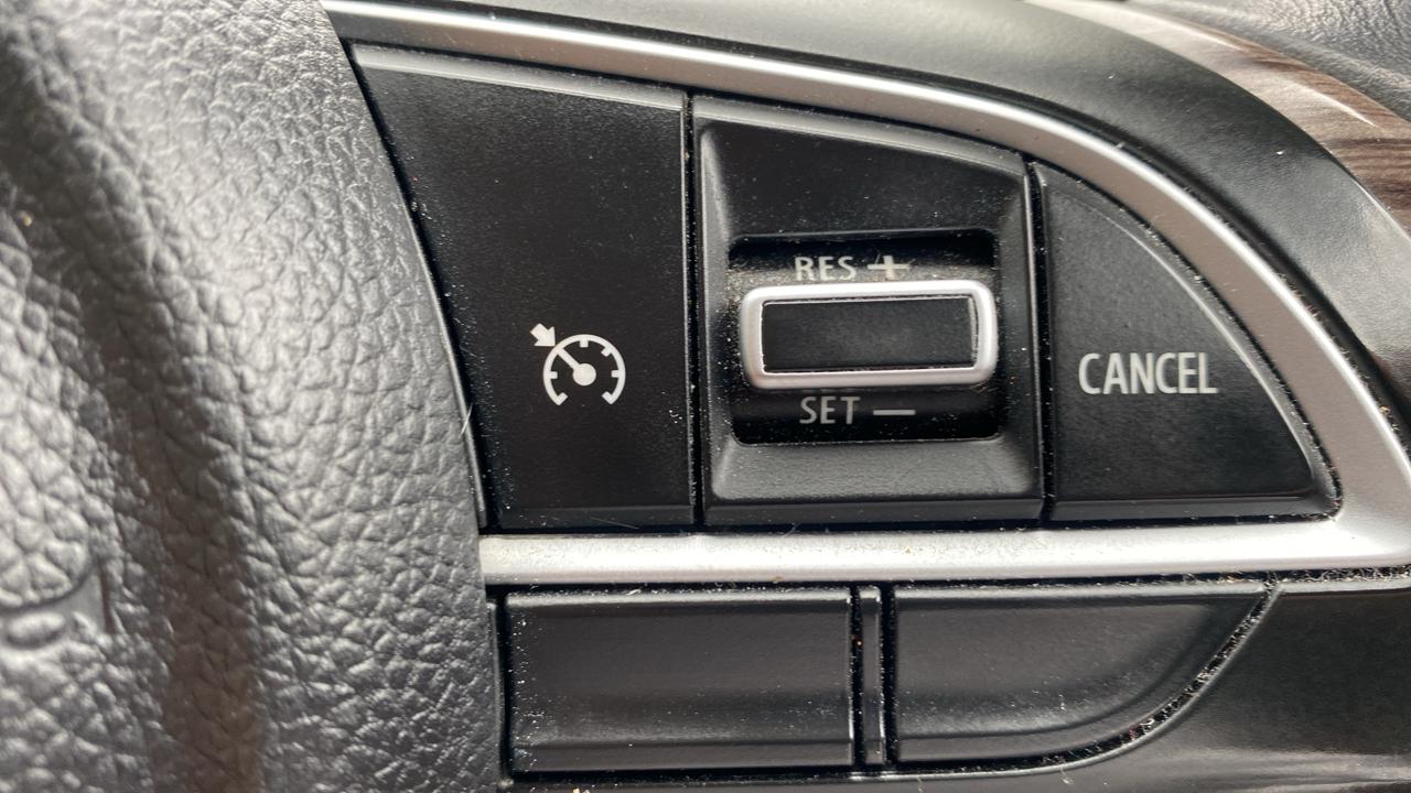 Cruise control buttons on a Maruti Suzuki Dzire steering wheel