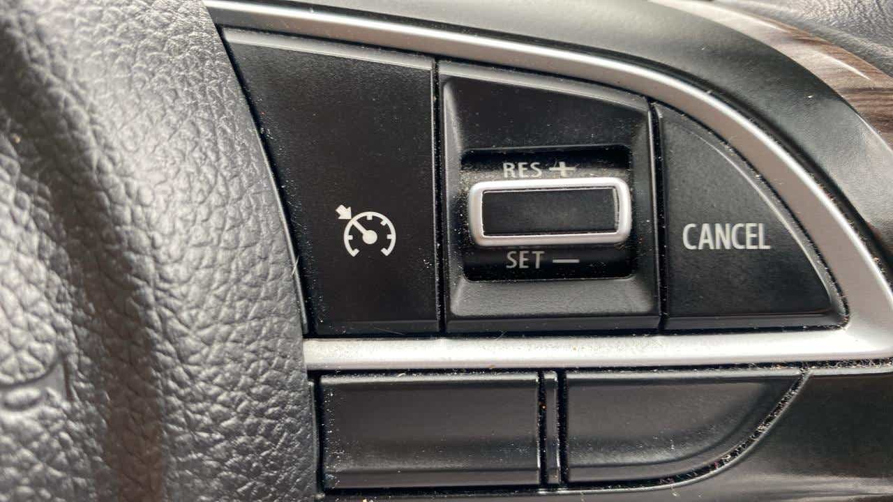 Cruise control buttons on a Maruti Suzuki Dzire steering wheel