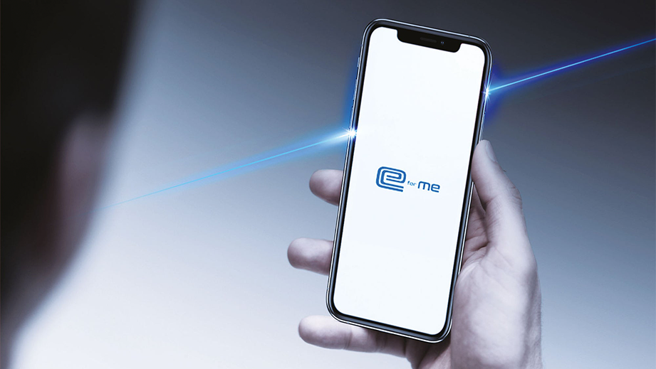 Person holding a smartphone showing the car app interface of a Maruti Suzuki e Vitara