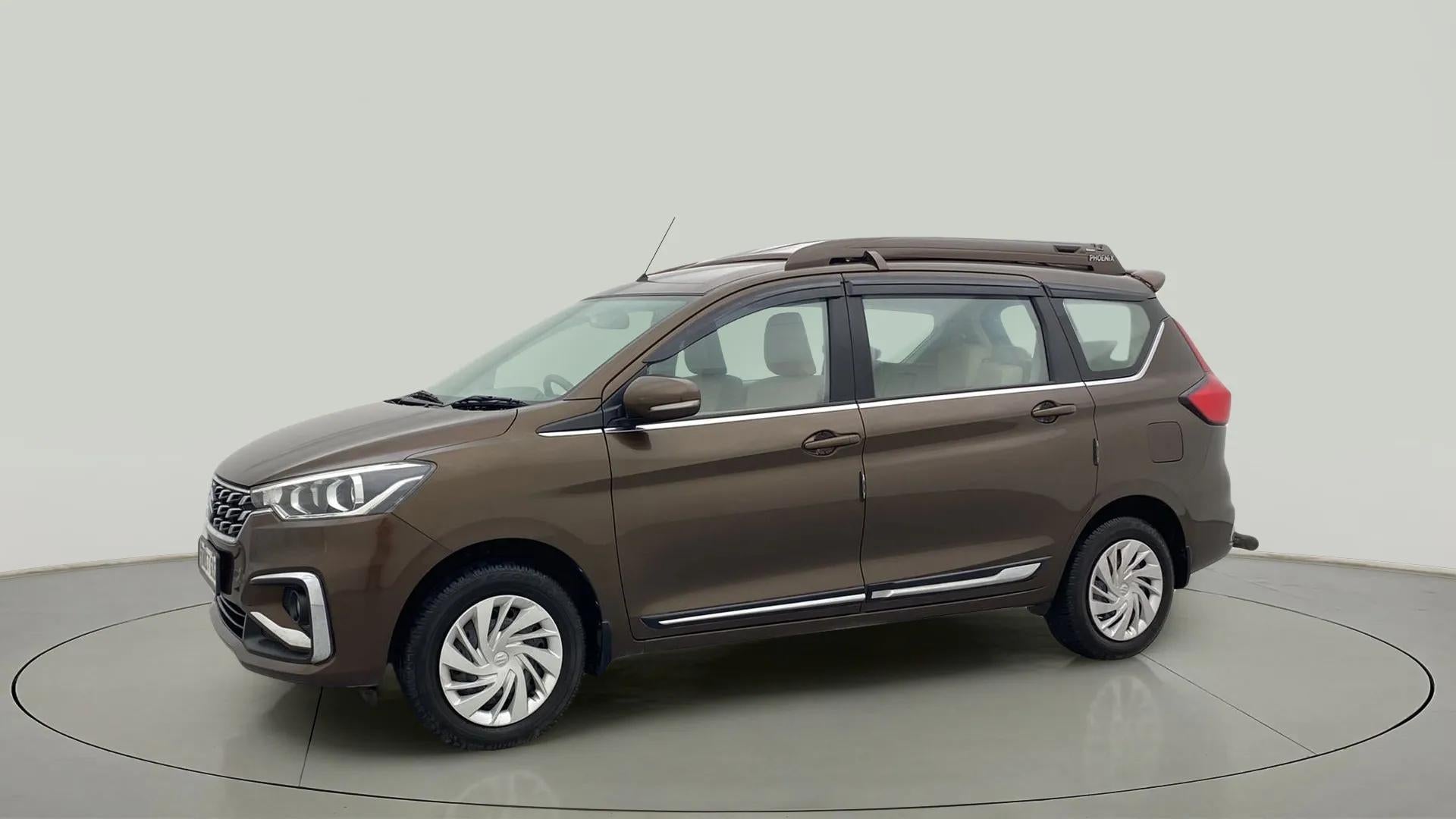 Side view of a Pearl Metallic Dignity Brown Maruti Suzuki Ertiga