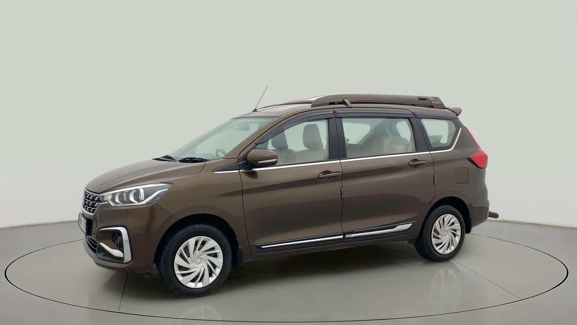 Side view of a Pearl Metallic Dignity Brown Maruti Suzuki Ertiga